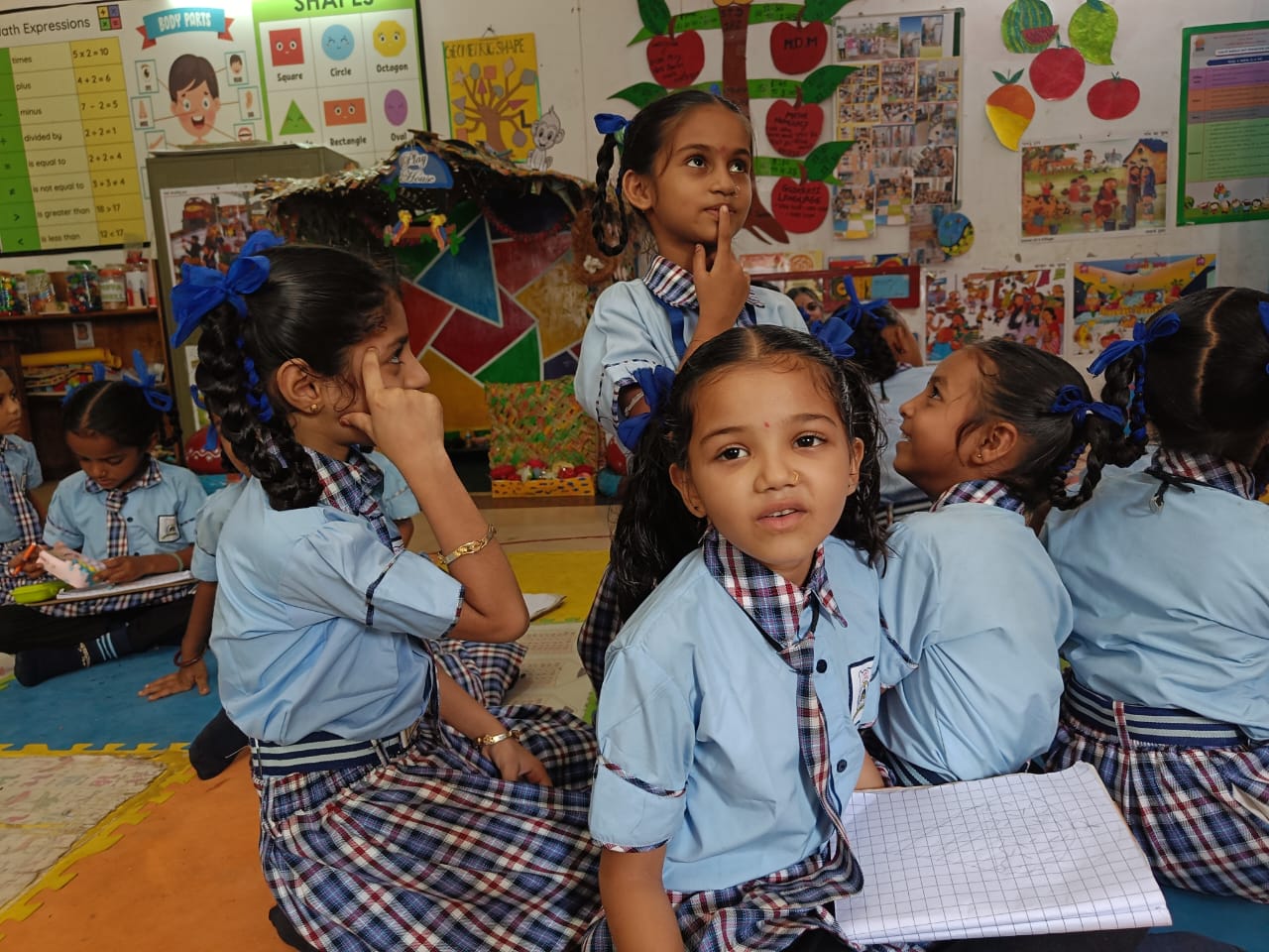 Children thinking and collaborating in a classroom